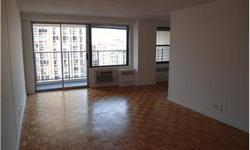 Spacious living room that leads out in to a balcony overlooking the upper west side, windowed kitchen with premium granite counters and stainless appliances lie off of it. Listing originally posted at http