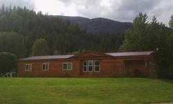 Log Sided MFG Home w /Shop! Sets in Cozy Metaline w Park & Boat Launch Acess to Pend Oreille River near. 4bd 2 bath , kitchen breakfast bar,dining rm , master suit w/bath & walk-n-closet,large open living rm,mud & laundry rm,shop has 220 and garage