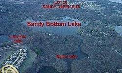 BUILD YOUR DREAM HOME ON THIS PREMIER LAKEFRONT PROPERTY OFFERING 7.54 WOODED ACRES W/ACCESS TO PRIVATE ALL SPORTS SANDY BOTTOM LAKE WITH WATERWAY ACCESS TO CHAIN OF LAKES. PROPERTY LOCATED AT END OF PRIVATE DRIVE IN HIGHLY DESIRED SANDY CREEK SUB AMONG