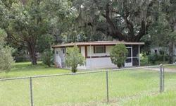 Great Price and Location! Beautiful mature oaks surround this 2 bedroom 1 Bath singlewide manufactured home. Nice and neat home with screened porch and spacious fenced yard. Great Lady Lake location close to The Villages, shopping, hospital, and terrific