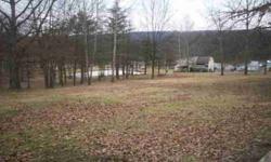 Possibilities are endless on this large tract encompassing 23 acres with 3 bedroom, 1 1/2 bath modified mobile home with 8 X 32 storage shed behind residence. Parcel includes panoramic views of the mountains and valley from perched upon the East side of