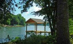 Brand new dock on this waterfront home site! Level lot with lovely view, near the mouth of a cove. Over 200' shoreline, stabilized w/rip rap. Lot is partially cleared and ready for you to build. Pull your boat up to the dock and start enjoying lakeside