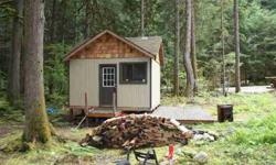 This 1 room cabin has expansion capabilities for up to 2-three beds has water, an lp stove & refrigerator, wood stove, 5kw generator for electrical power, a double hide-a-bed, & is wired for telephone.