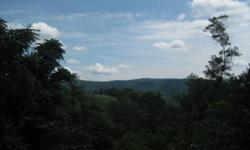 5.29 acres in Sneedville, TN (Hancock Co.) - Mountain land with deeded access road, power and small spring fed pond. This tract has great views of surrounding valleys and ridges. The terrain is hilly with many great home sites with good views. There is a