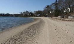 Beach house sitting on a Knoll with panoramic views of Buttermilk Bay and the Cape Cod Canal Railroad Bridge. Steps to the white sands of Indian Heights Association Beach and the warm protected waters of the Bay. Views like a direct waterfront but without