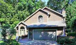 Surrounded by woods, this magnificent two-story sits on an incredible private lot steps from Lake Minnetonka! Beautiful sun room large deck, nicely landscaped, new roof, washer/dryer, and other recent updates, plus two storage sheds. This one's