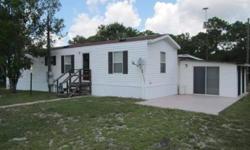 Furnished mobile home on private road in area of winter residence. You own the land & no HOA fees. This is an older unit with additions. 2005 mobile home in like new condition with neutral color carpet & w faux tile vinyl floors. The kitchen is open and