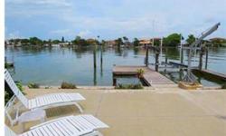 Beautifully updated waterfront home with dock, 12,000 lbs lift and davits. Gorgeous open kitchen with granite counters, work station and breakfast bar. Easy maintenance tile and wood floors throughout. Bayside master suite with soothing water view. Huge,