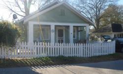 Charming vintage cottage in the heart of Commerce! White picket fence, rocking chair porch complete with porch swing and an herbgarden - all that as you enter the front door! Hardwood floors in the living area. Carpeted bedrooms. Antique fireplaces
