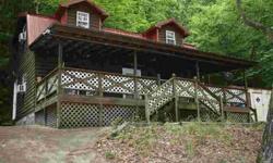 Enjoy the summer with a cute cabin on the lake. On the main floor there is a kitchen with breakfast bar, living room and a full bath. Upstairs in a large bedroom with a half bath. There is a covered front porch. There is a mobile home on the property that
