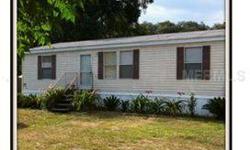 Want to get away from the hustle and bustle? Nice 3BR 2 BA mobile home is situated on a private lot which is approximately 1/2 acre. Home has its own well, newer sewer system, central heating and A/C, an exterior work shed, and large detached 3 car garage