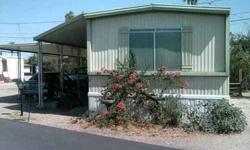 1978 Arizona mobile home. 14 x 60'. Two bedroom, two full bathrooms (one with a shower and one with a bathtub), laundry room, kitchen with dining area. Divided floor plan with bedrooms at opposite ends of home. No carpet, all laminate wood and tile floors