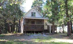 Don't miss this adorable & cozy cabin in the pines of Meadow Lakes. There's a great screened-in front porch, new carpet & paint & newer propane stove. Some updating has already been done. There's one bedroom on main floor (needs a doors to close off) and